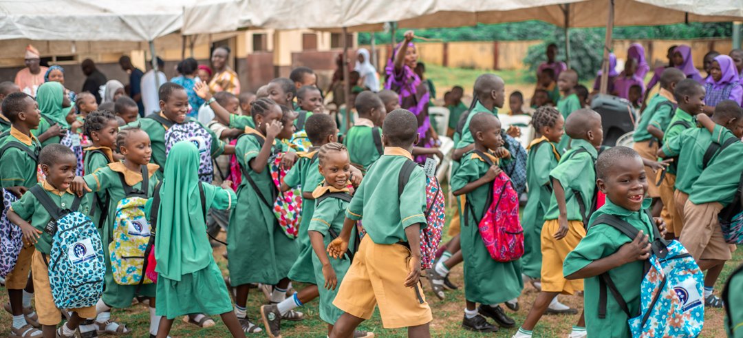 Pupils with new school bags at a Wole Ogunyemi Foundation schools outreach in Osogbo, Nigeria